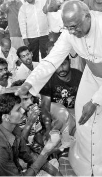 Bishop of Tuticorin Roman Catholic Diocese Rt. Rev. Yvon Ambroise offering juice to a protester at Idinthakarai on Thursday. — Photo: A. S.