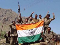Indian soldiers with tri-colour in Kargil.