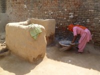 Dalit woman cleaning a dry latrine