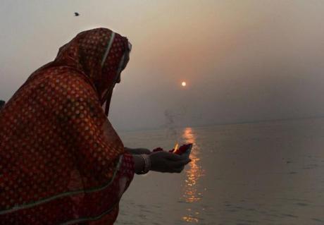 Pilgrim offering a lamp to Ganga Devi