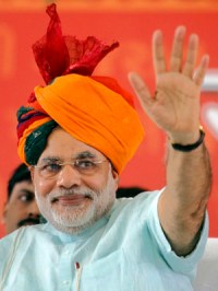 Gujarat's CM Modi wears traditional Indian turban as he waves to his supporters.