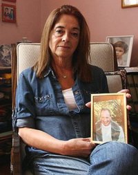 Graciela Yorio holding photo of her tortured Fr. Orlando Yorio SJ