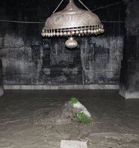 Kedarnath linga in silt with bilva leaves.