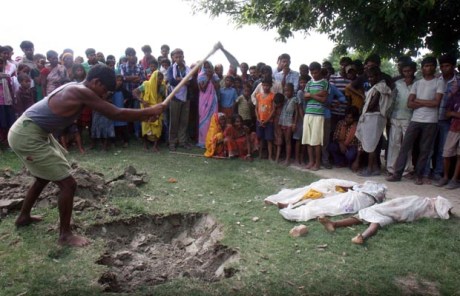 Dead school children are buried in the school yard itself as a protest against the Bihar government. Dead school children are buried in the school yard itself as a protest against the Bihar government.
