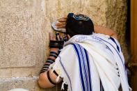 Jewish man praying at the Western Wall (Jerusalem)