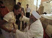 Yazidi holy man blessing a devotee at Lalish