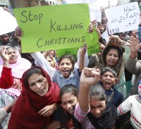 People from the Christian community attend a protest to condemn suicide bombings which took place outside two churches in Lahore