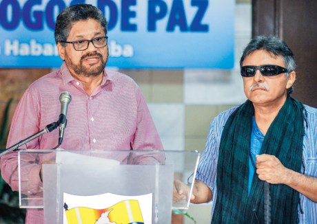 Commander of the FARC-EP leftist guerrillas, Ivan Marquez (left), reads a statement during peace talks with the Colombian government next to FARC commander Jesus Santrich in Havana on September 11, 2015. Ivan Marquez & Jesus Santrich
