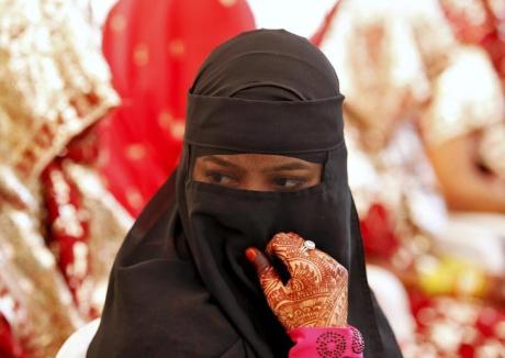 A Muslim bride waits for the start of a marriage ceremony in Ahmedabad