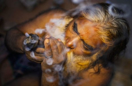 Sadhu smoking Shiv prasad (ganja) at Kathmandu Pashupati Temple. Sadhu at Pashupati Temple Kathmandu