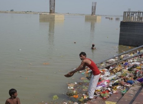 Ganga ghat steps strewn with garbage.
