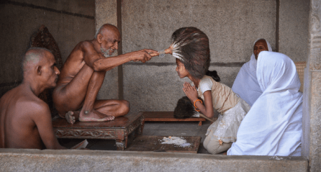 Jain muni blessing school girl.