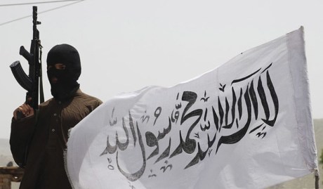 Taliban fighter with flag.