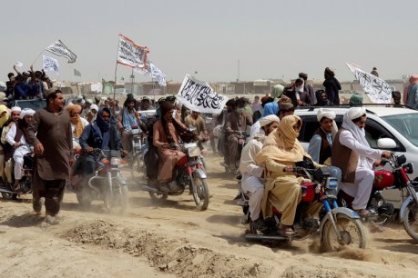 People on vehicles, holding Taliban flags, gather near the Friendship Gate crossing point in the Pakistan-Afghanistan border town of Chaman, Pakistan on July 14, 2021. 
