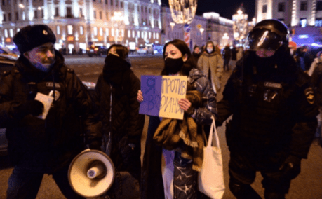 Police arrest anti-war protester in Moscow.