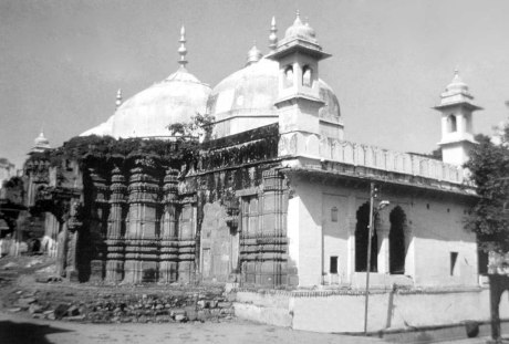 The western wall of the original temple of Kashi Vishwanath with Auranzeb's mosque standing atop it.