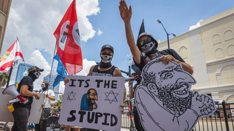 Demonstrators hold anti-Semitic signs as they protest in Tampa, Florida (July 23, 2022).
