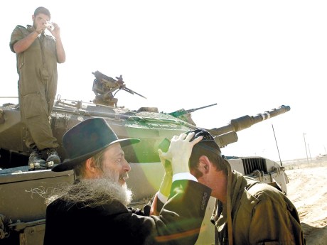 Jewish rabbi blessing an Israeli soldier. Rabbi blessing an Israeli soldier.