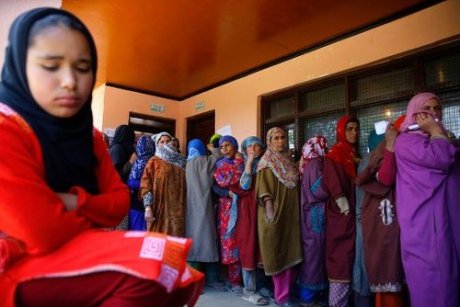 Muslim women wait to vote in Kashmir.