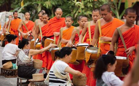 Buddhist monks begging food from householders. Thai monks begging food from householders.