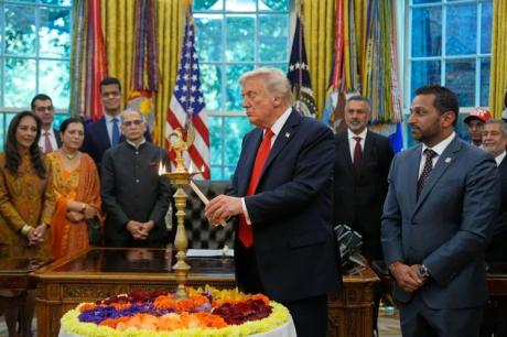 President Trump lights a lamp in the Oval Office for Diwali 2025.