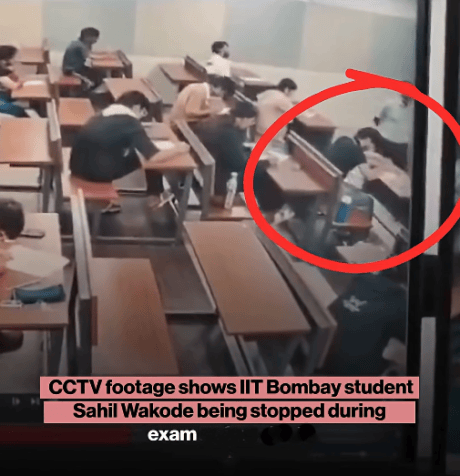 IIT student being stopped during exam by invigilator.